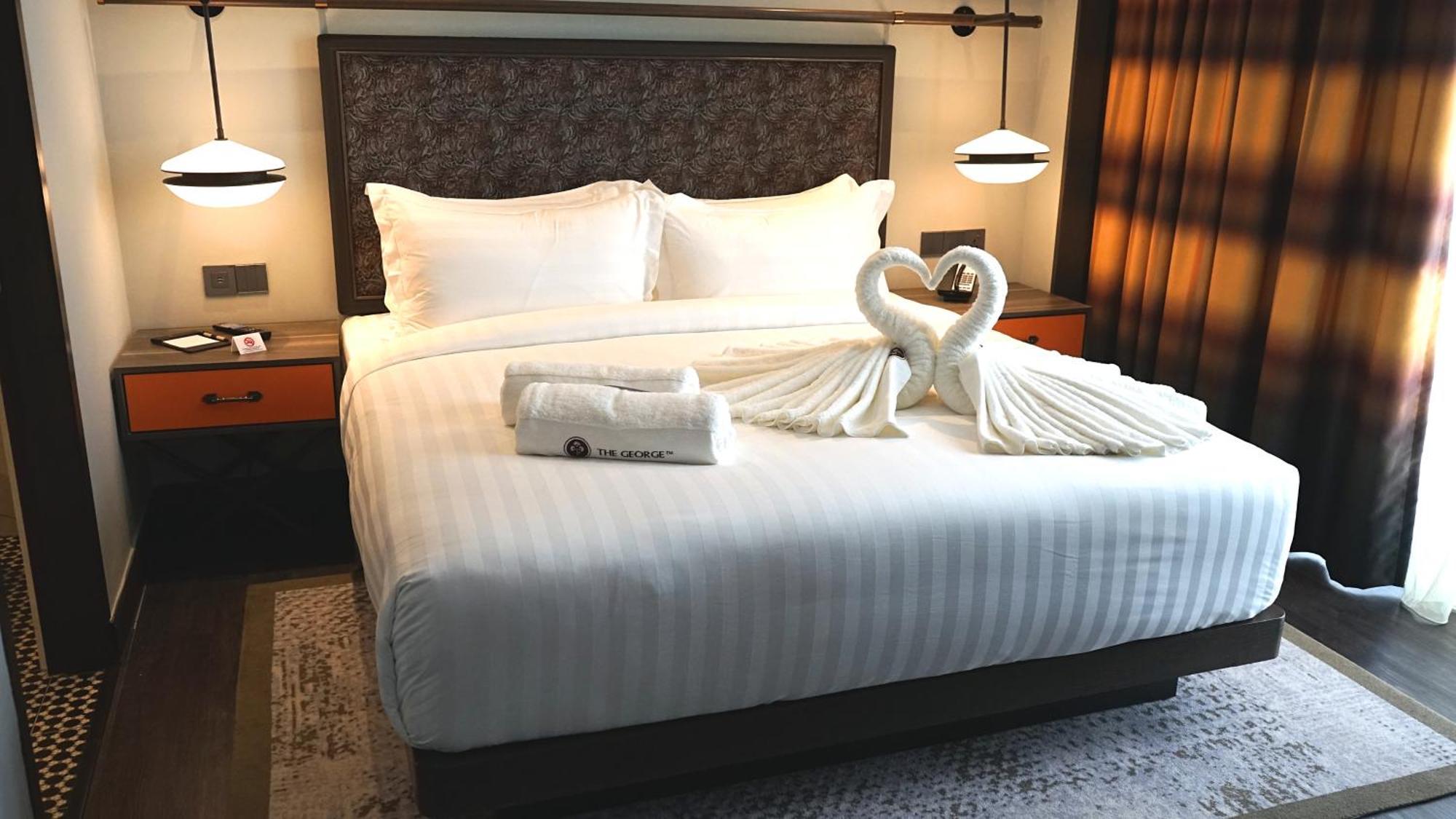 The George Penang By The Crest Collection Hotel George Town Exterior photo A bed with a swan shaped towel